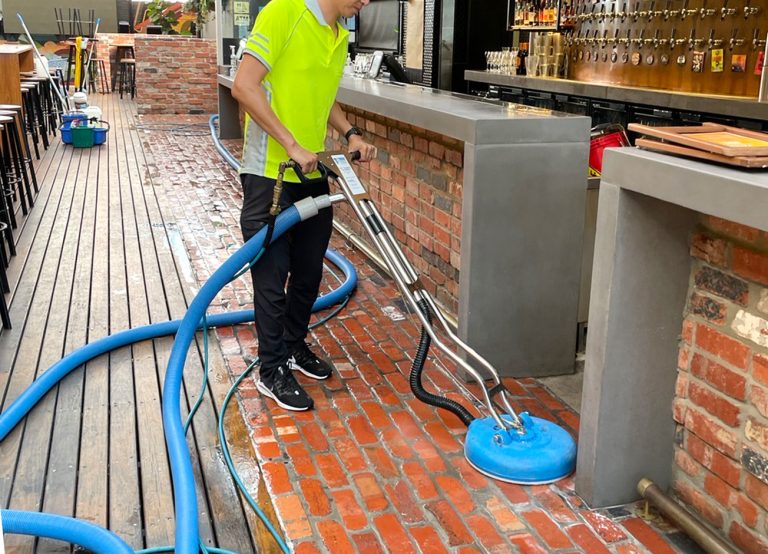 Working using modern equipment while performing professional office cleaning | Featured Image for the Office Cleaning Services Page of QCS Cleaning_