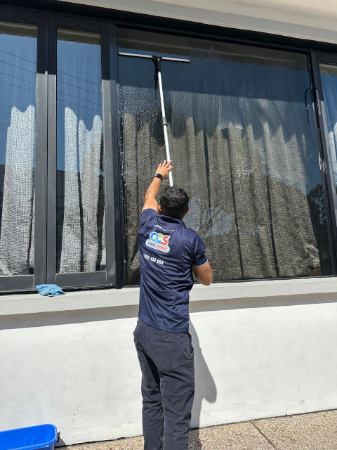 QCS Cleaning Services Cleaning a Large Glass Window